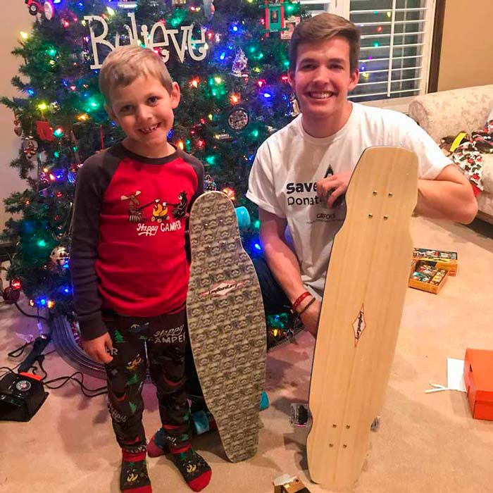 Father and son celebrating Christmas with their Longboard Larry decks