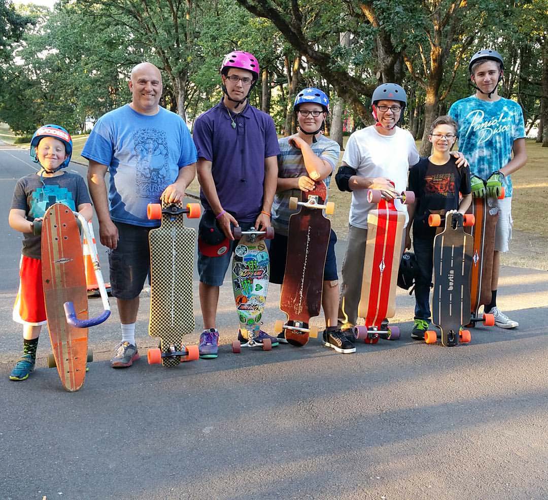 Longboard Larry with a group of skaters enjoying their boards